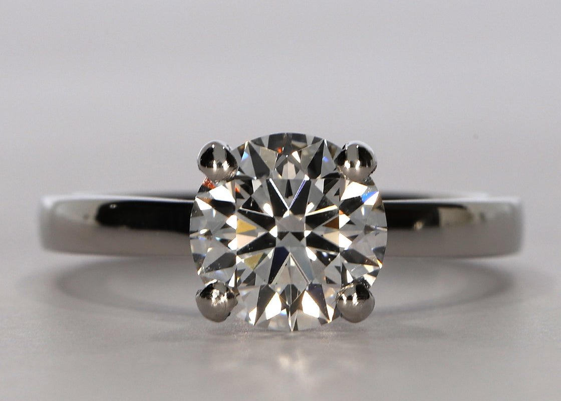 1477 Classic ring in Platinum set with a Round 1.31ct E - Extremely White VVS2 - Lab - grown Diamond. Our timeless classic design combines simplicity with elegance. The diamond sits proudly on a flat band with a band width of approximately 2mm - Prestige Stones