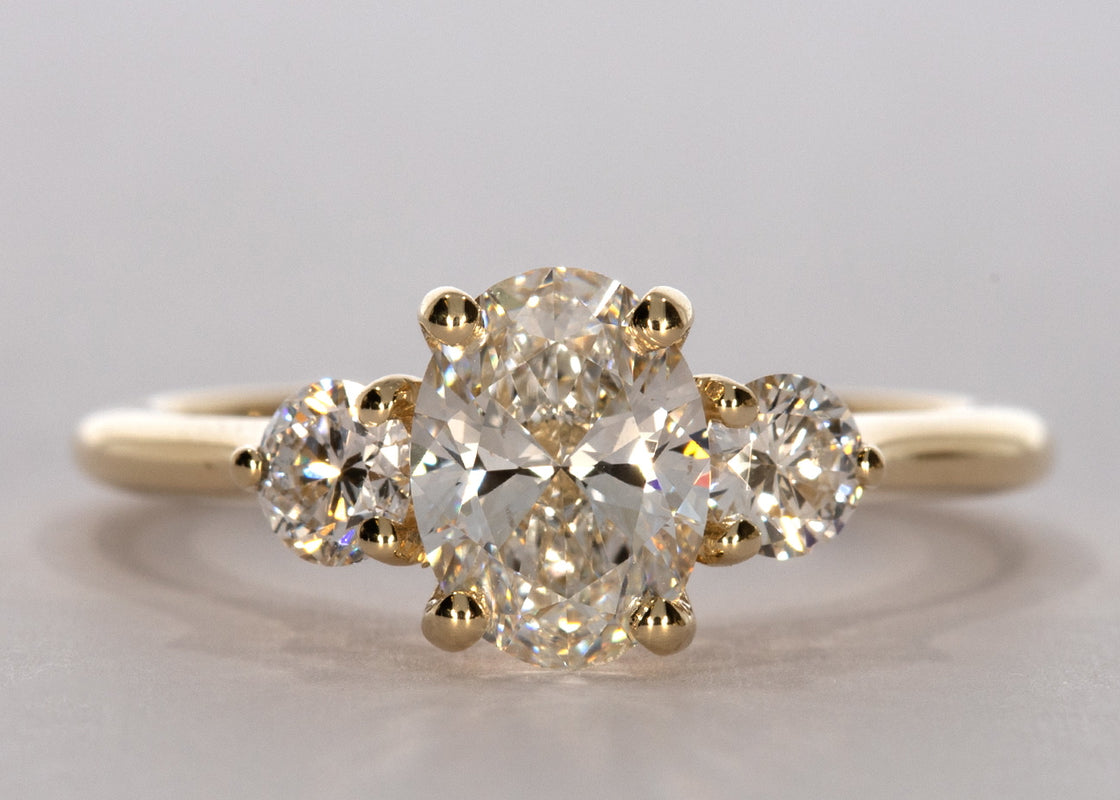 Valencia ring in Yellow Gold set with a Oval 1.06ct. D - Perfectly White VVS1 - Diamond. With a total carat weight of 0.30ct and a 1.8mm rounded D-shape band.