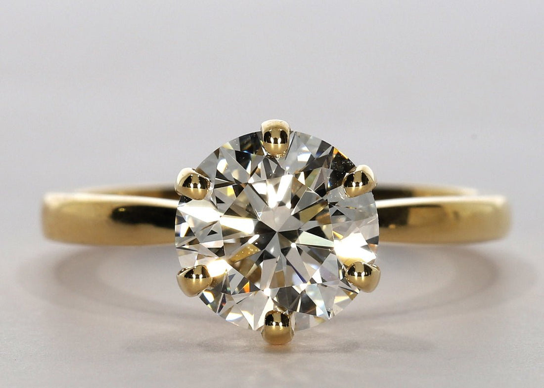 Grace ring in Yellow Gold set with a Round 2.00ct. E - Extremely White VVS2 - Lab - grown Diamond. This delicate ring showcases 6 claws with a 2mm band that tapers towards the diamond to enhance size and brilliance - Prestige Stones