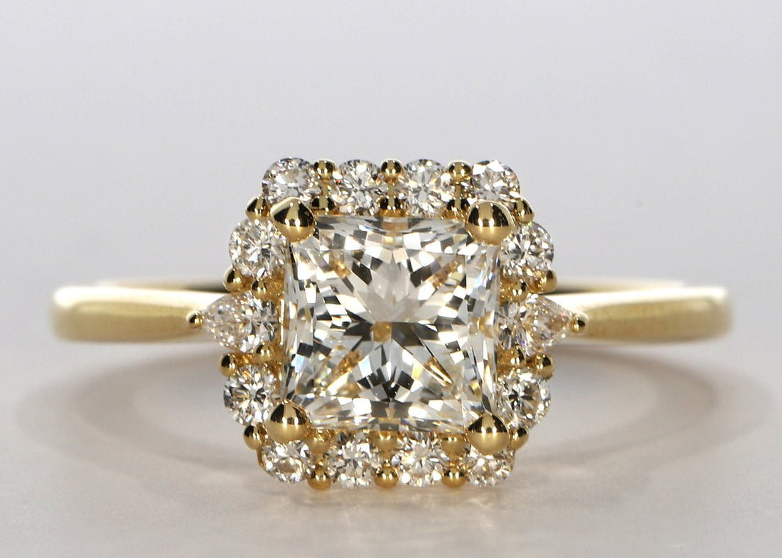 Hampstead ring in Yellow Gold set with a Princess 2.01ct ct. G - Very White VVS1 - Natural Diamond. This setting features a round brilliant and pear diamond halo, for a total carat weight of approx 0.66ct, on a 2.0mm plain band. - Prestige Stones