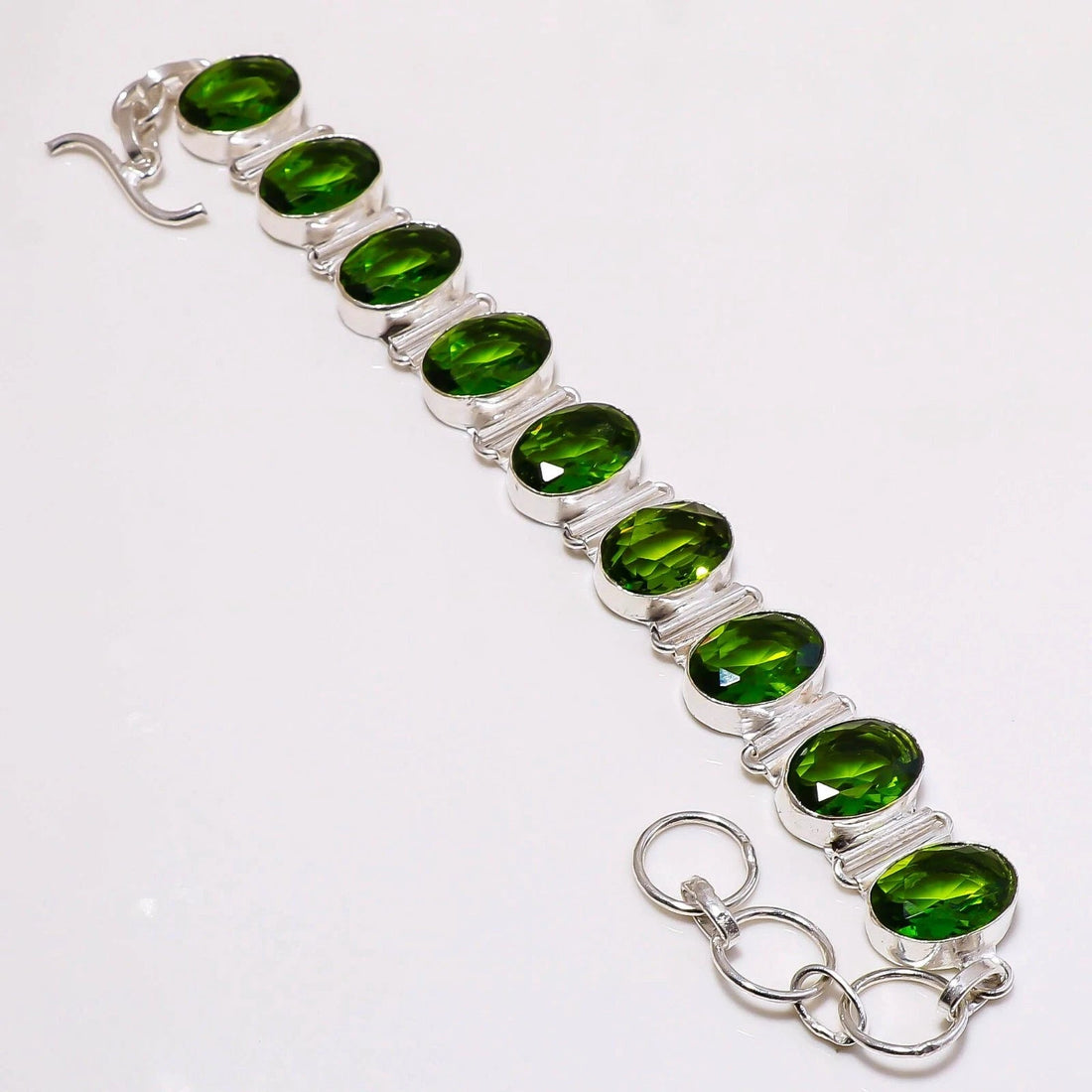 Handcrafted 925 sterling silver bracelet with nine oval-cut lab-created peridot stones – adjustable 7–8 inches