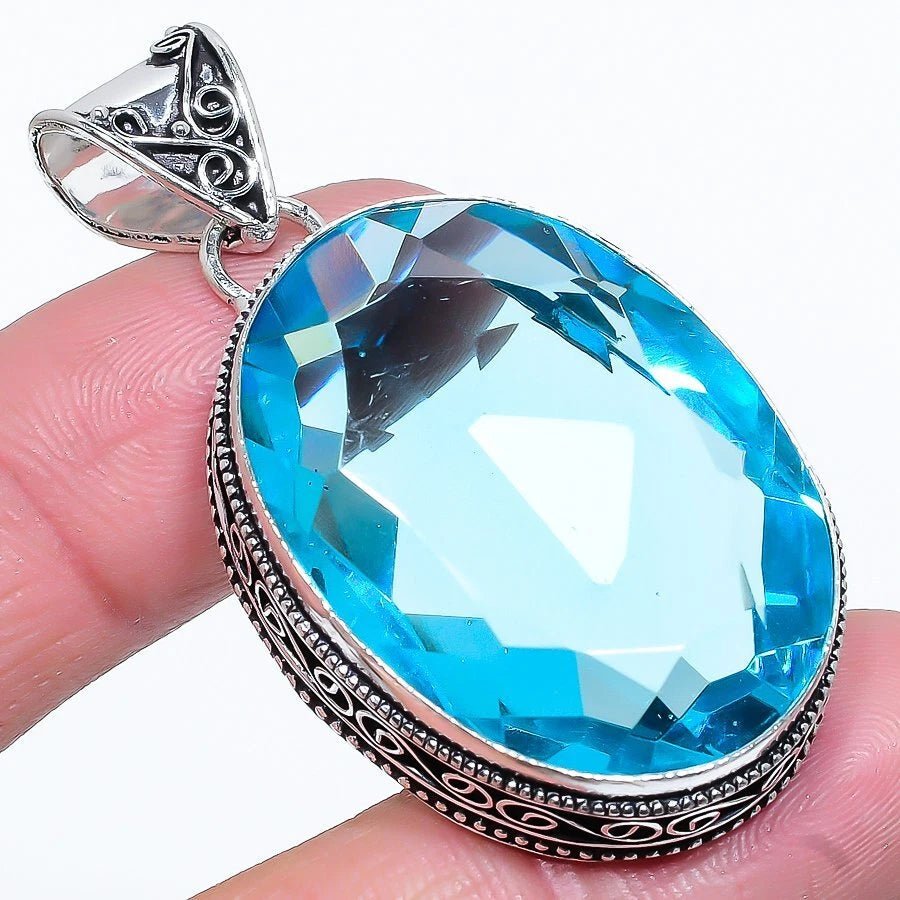 Handcrafted 925 sterling silver pendant with lab-created Swiss blue topaz and ethnic-inspired silver detailing