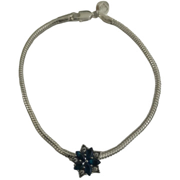 Silver-plated snake-chain bracelet with deep blue marquise crystals floral charm and clear pavé accents