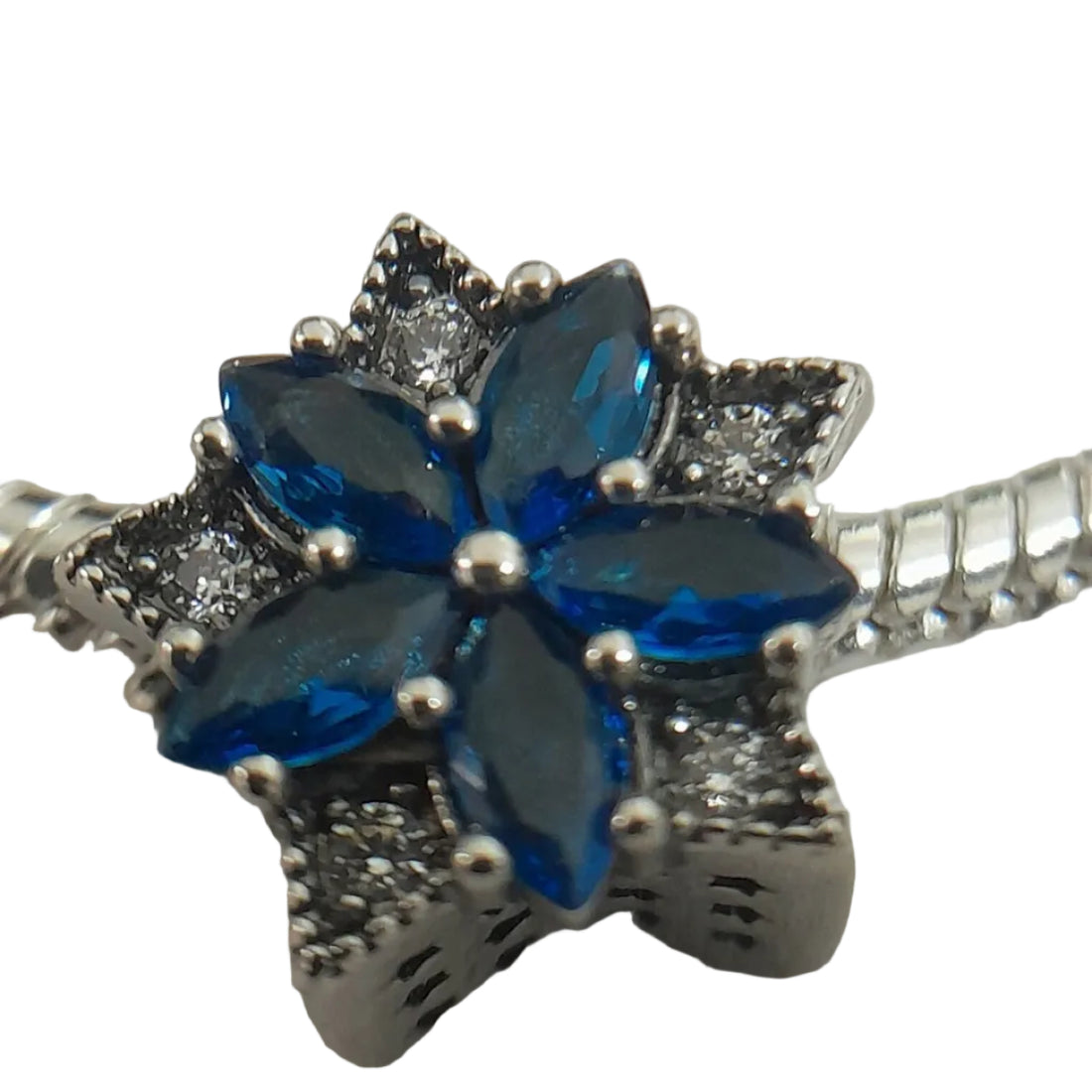 Silver-plated snake-chain bracelet with deep blue marquise crystals floral charm and clear pavé accents