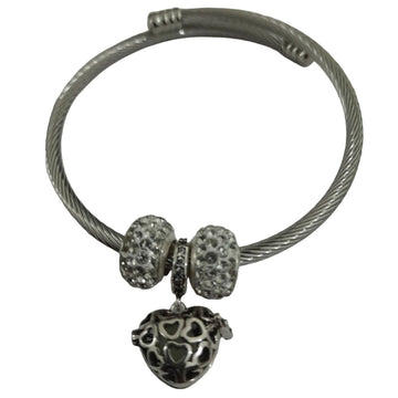 Silver-plated twisted-wire cable bangle with pavé crystal beads and filigree heart charm, flexible open-ended design for everyday wear