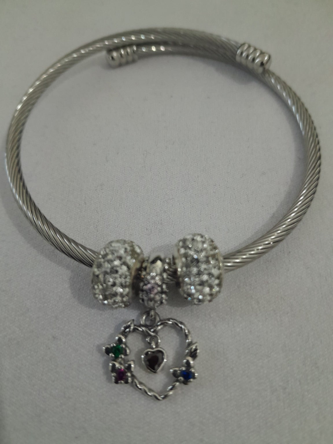 Essentials silver-tone twisted cable bangle with multicolour heart charm and pavé crystal beads